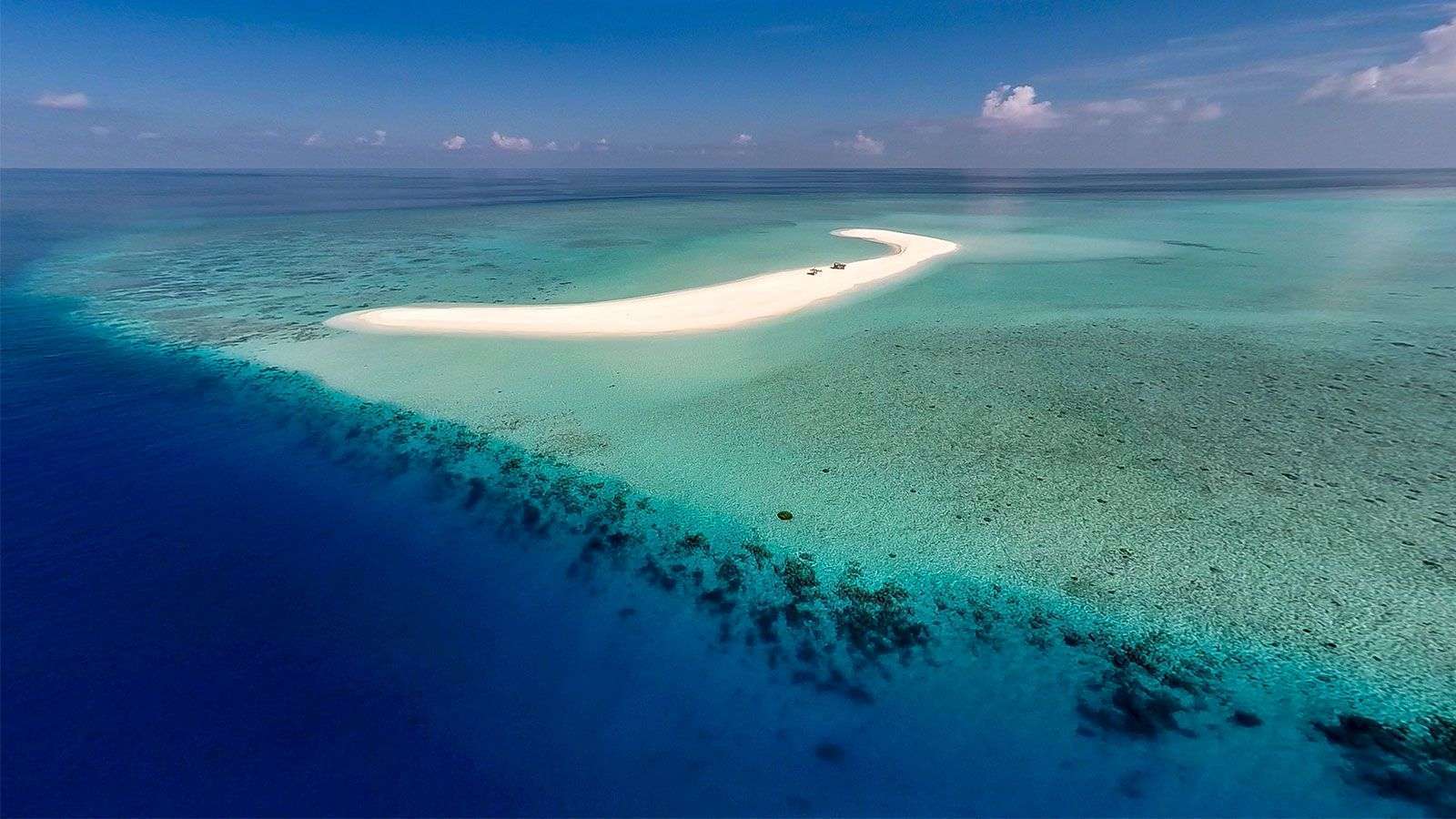 A private dining table set on the Dream Island sandbank